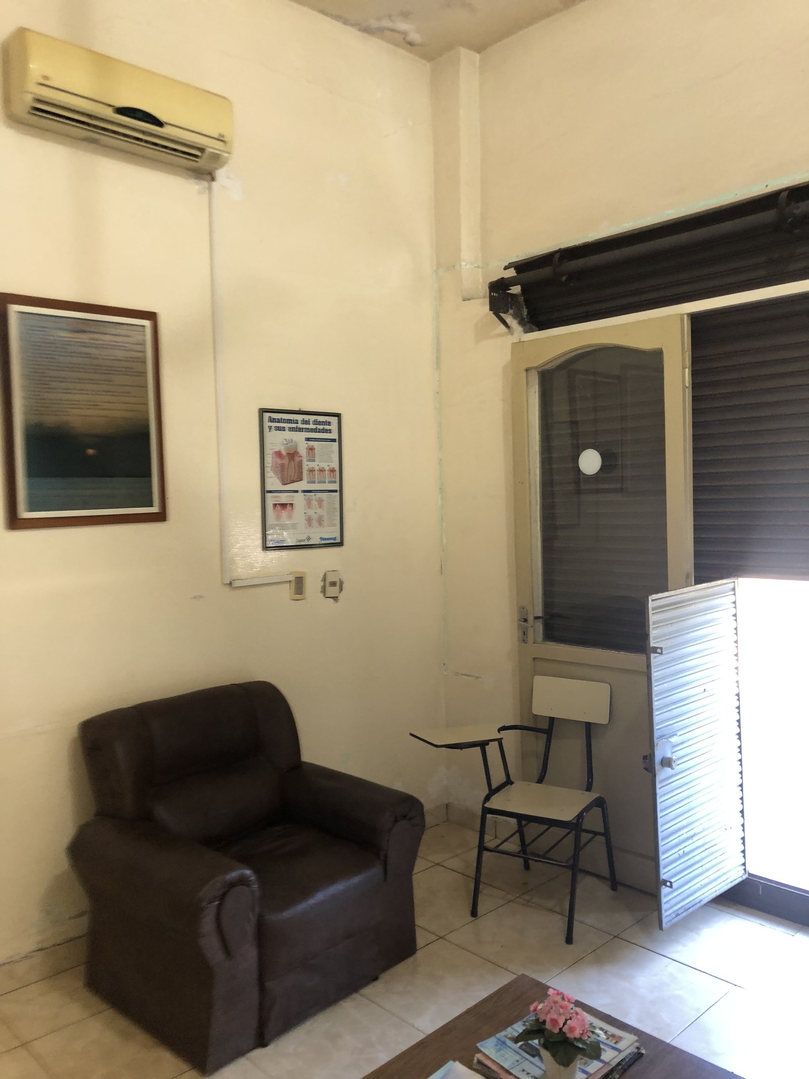 Sala de espera con sofa y cuadros, consultorio San Lorenzo - OGA Constructora