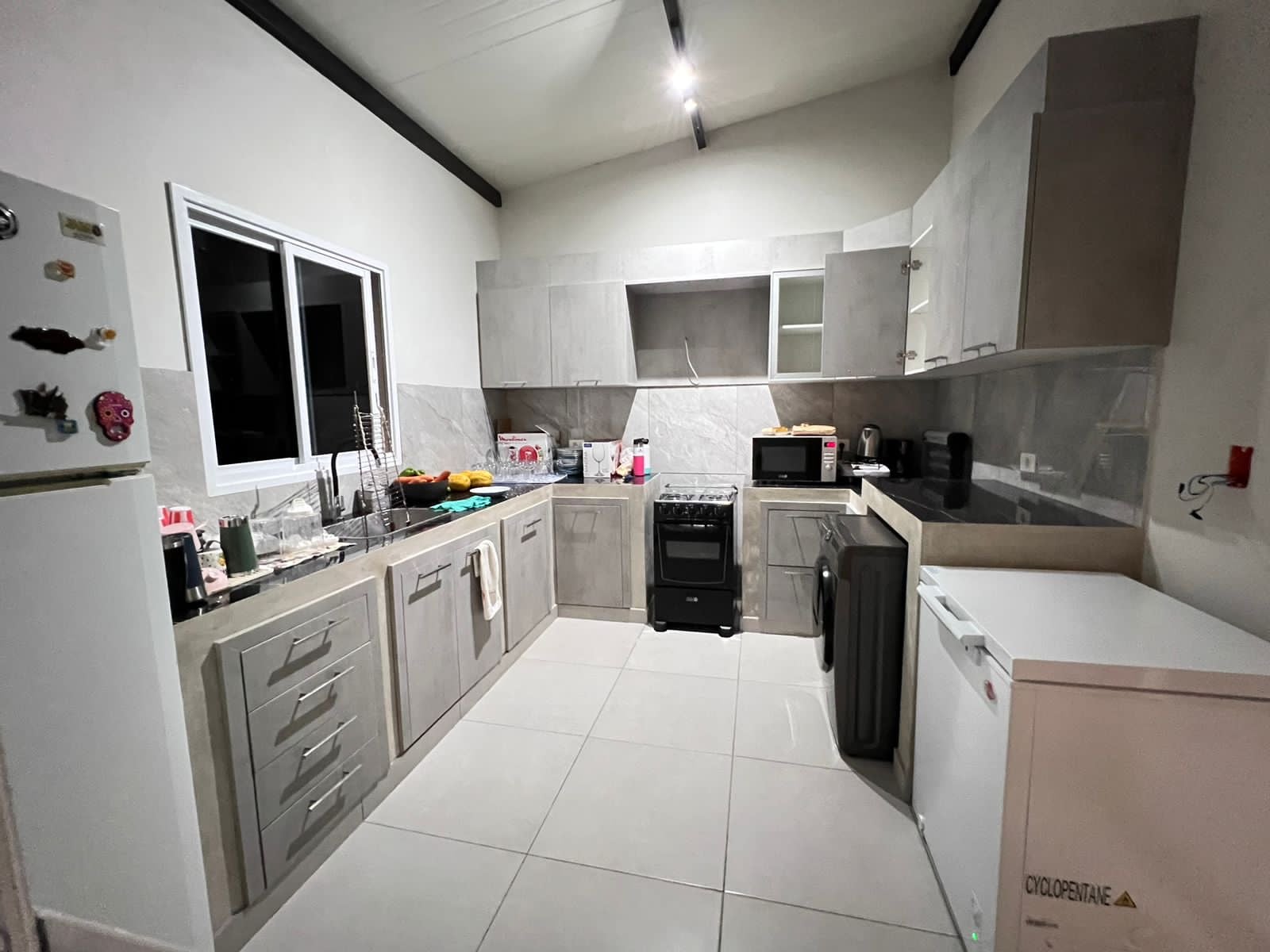 Cocina moderna con muebles blancos en vivienda terminada, Yaguaron - OGA Constructora
